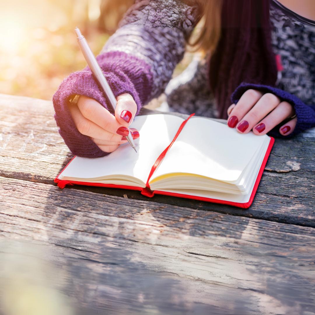Woman writing in notebook