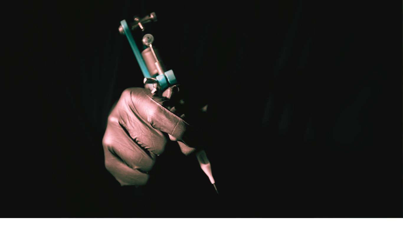 Tattoo Artist man holding tattoo gun