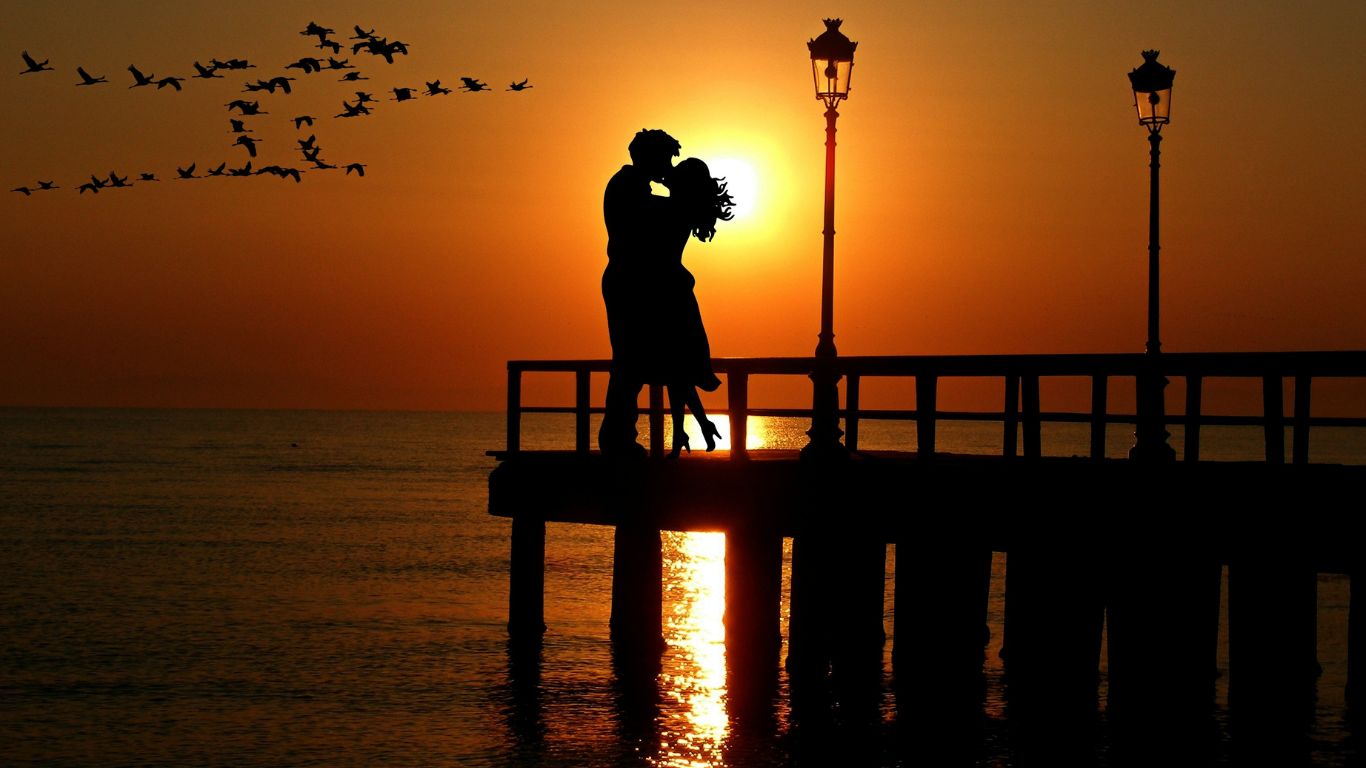 Lovers on a peer at sunset